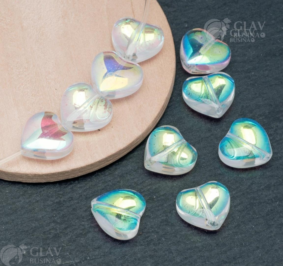 Бусины-сердечки из прозрачного стекла с АВ покрытием, размеры 10.5х11х5.7мм и отверстие 0.9мм. Имеют потертости на покрытии.